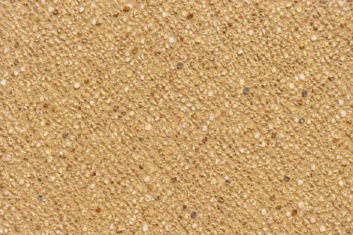 Close-up of buff high friction surfacing on a road junction approach