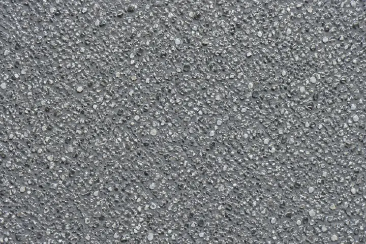 Close-up of grey anti-slip coating on a car park ramp