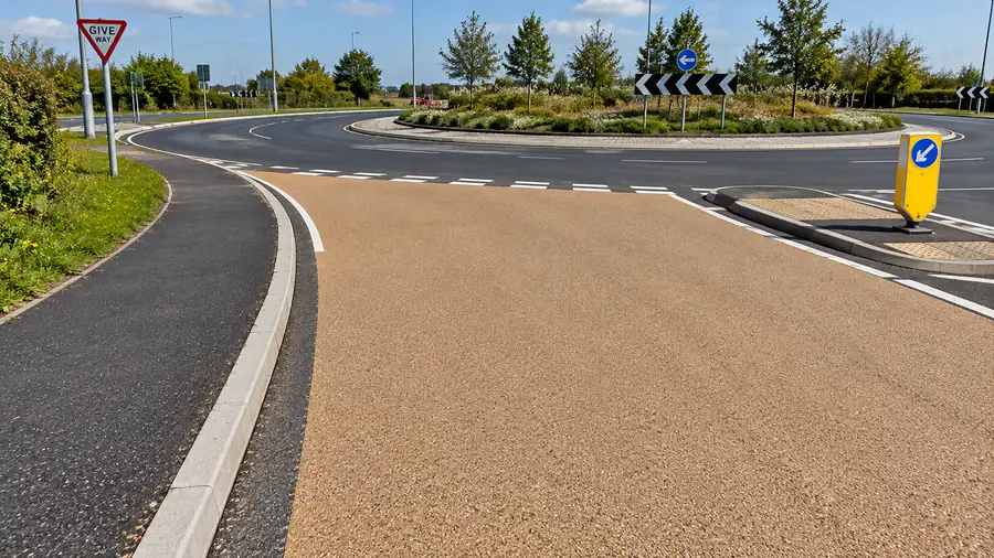 Buff high friction surfacing laid on a roundabout approach with give way markings