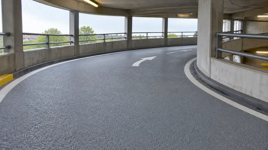 Grey anti-slip coating on a multi-storey car park spiral ramp
